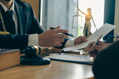 Man In Black Suit Reading A Legal Document Carefully Using Magnifying Glass