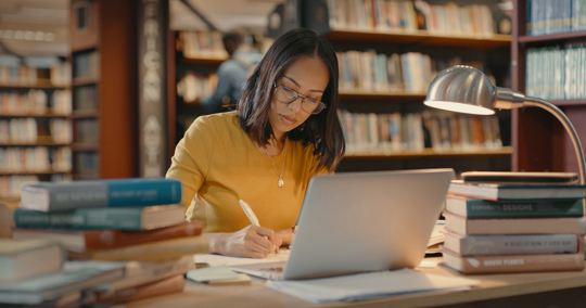 woman in a library studying