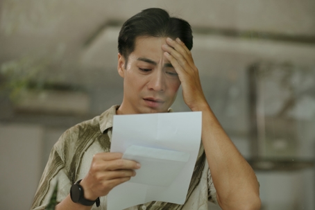 worried young man reading a letter