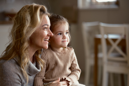 daughter sitting on mother's lap