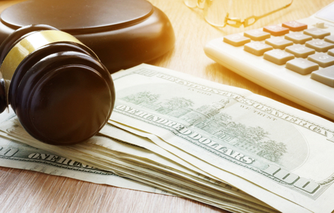 a gavel, money, and a calculator