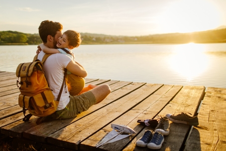 father and son hugging on the dock