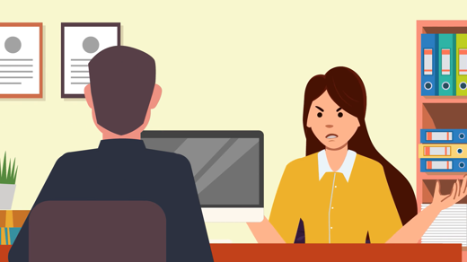 Two people talking at desk